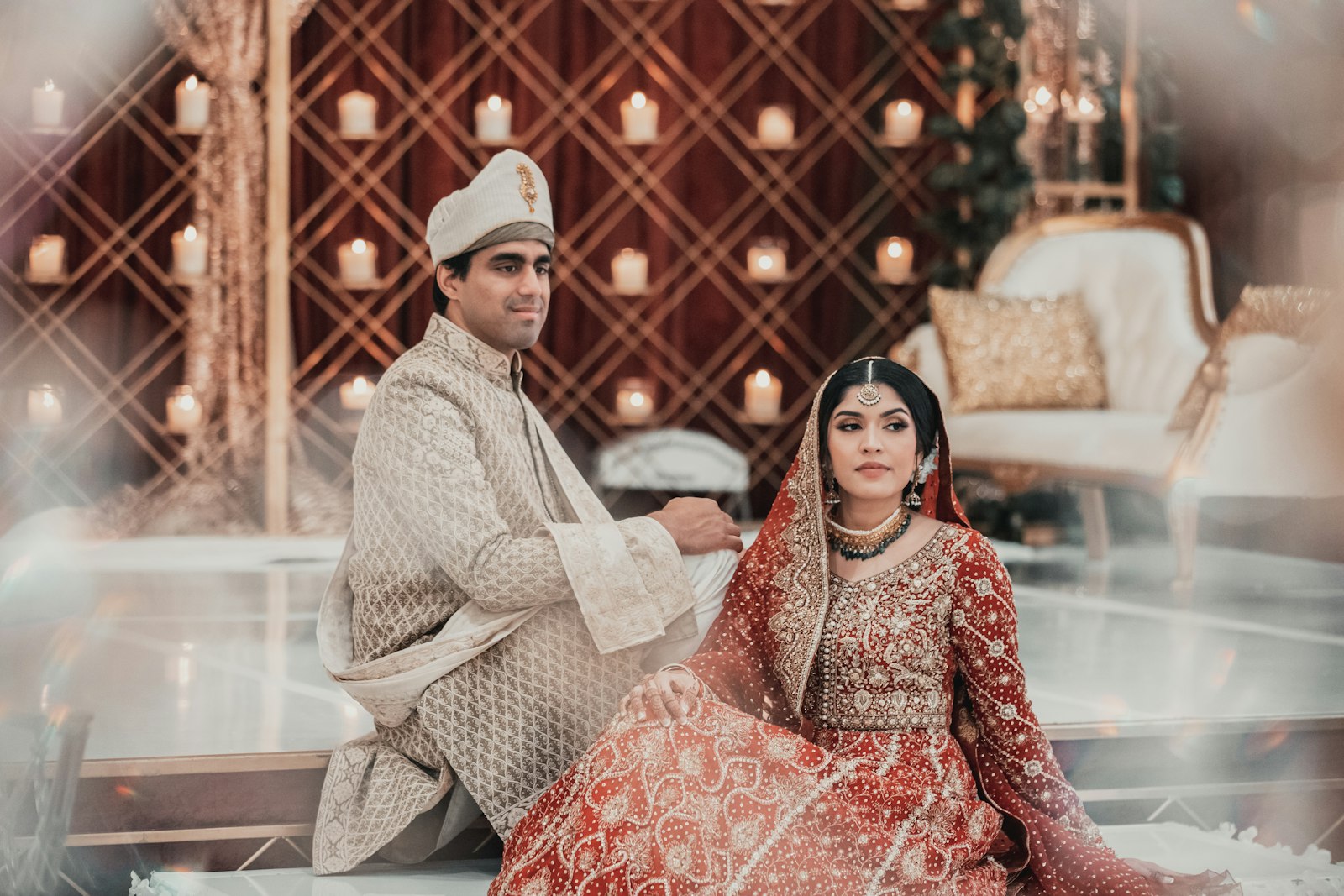 Muslim bride and groom seated together in wedding attire